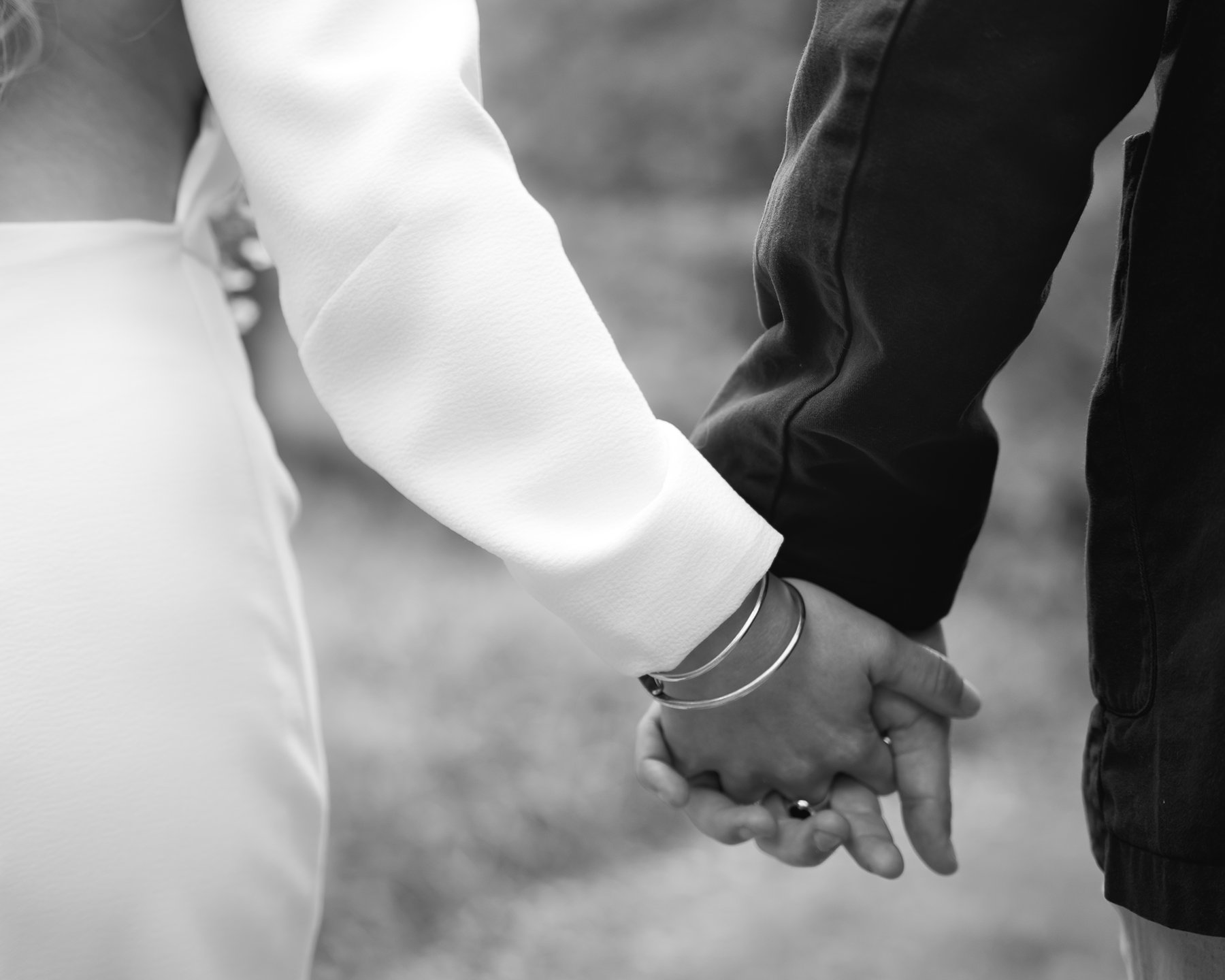 Close up of holding hands on wedding day.